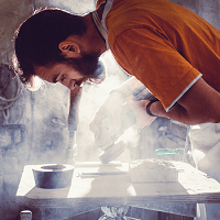 A worker experiencing airborne dust hazards without protection